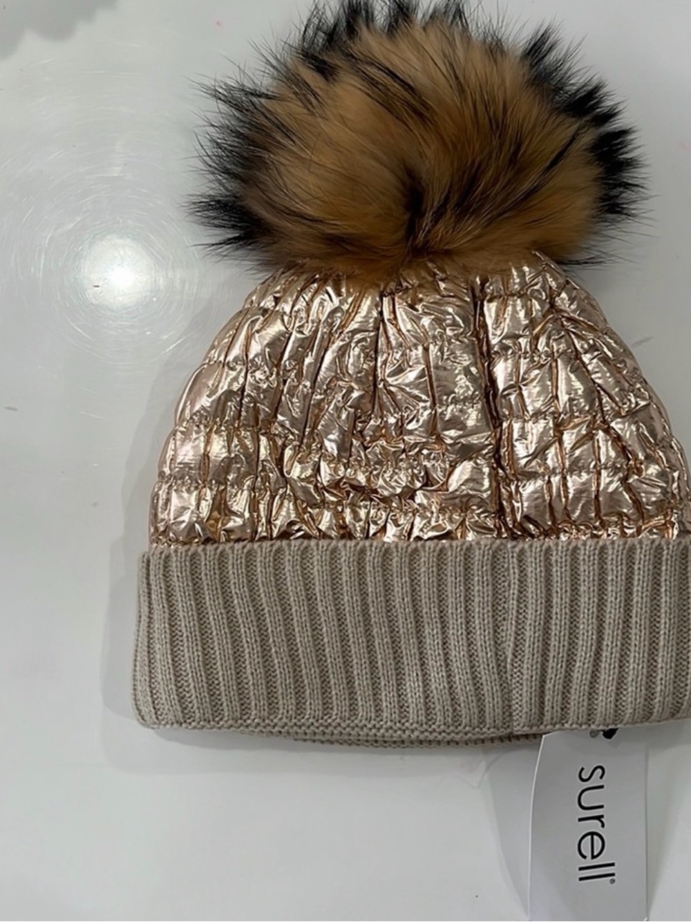 Surell Rose Gold Quilted Beanie with Fur Pom